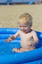 A little boy splashing in an inflatable pool Royalty Free Stock Photo
