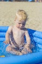 A little boy splashing in an inflatable pool Royalty Free Stock Photo