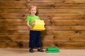 Little boy with stack of books at wooden wall Royalty Free Stock Photo