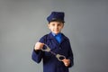 The little boy stand in a police costume and saluted