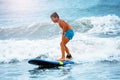 Little boy stand on the surfboard learn to ride Royalty Free Stock Photo