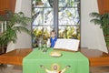 Little boy standing by the altar table