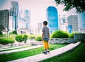 Little boy standing looking the buiding in the city park Royalty Free Stock Photo