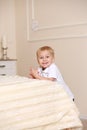Little boy standing near the bed Royalty Free Stock Photo