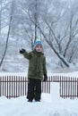 A little boy is standing on a snow hill Royalty Free Stock Photo