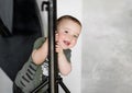 The little boy stands relying on the rack Royalty Free Stock Photo