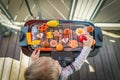 A little boy starts grilling by playing with his vegetables and sausage food toys at the balcony. He is creating a Royalty Free Stock Photo