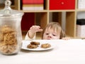 Little boy stealing cookies Royalty Free Stock Photo