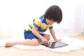 Little boy in striped t-shirt with tablet computer Royalty Free Stock Photo