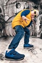 The little boy in the style of Hip-Hop . Children`s fashion.Cap and jacket. The Young Rapper.Graffiti on the walls.Cool rap dj. Royalty Free Stock Photo