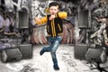 The little boy in the style of Hip-Hop . Children`s fashion.Cap and jacket. The Young Rapper.Graffiti on the walls.Cool rap dj. Royalty Free Stock Photo