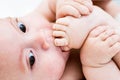 Little boy sucking toes on her feet Royalty Free Stock Photo