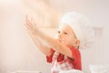 Little boy in a suit of the cook sculpts pizza dough. Baby make dinner