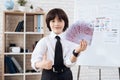 A little boy in a suit presents himself as a businessman. The dark-haired boy plays a rich man. Royalty Free Stock Photo
