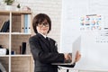 A little boy in glasses and suit presents himself as a businessman. The dark-haired boy plays a rich man. Royalty Free Stock Photo