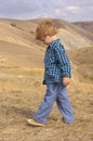 Little boy in summer mountain