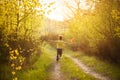 Little boy in summer sunny day holding windmill in hands and runing. Back view