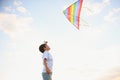 Little boy on summer vacation having fun and happy time flying kite on the field. Royalty Free Stock Photo