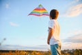 Little boy on summer vacation having fun and happy time flying kite on the field. Royalty Free Stock Photo