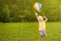 Little boy on a sunny day launches a flying kite. Royalty Free Stock Photo