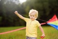 Little boy on a sunny day launches a flying kite Royalty Free Stock Photo