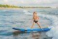 Little boy surfing on tropical beach. Child on surf board on ocean wave. Active water sports for kids. Kid swimming with Royalty Free Stock Photo