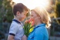 Little boy surprising mom with tulips