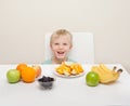 A little boy surround by fruit. The child is photographed again Royalty Free Stock Photo