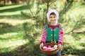 Little boy in sweater and hat waiting for a Christmas in the wood Royalty Free Stock Photo