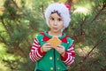 Little boy in sweater and hat waiting for a Christmas in the wood Royalty Free Stock Photo