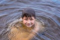 Little boy swimming in a lake