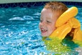 Little boy swimming with life vest on Royalty Free Stock Photo