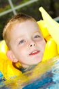 Little boy swimming with life vest on Royalty Free Stock Photo