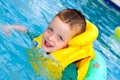 Little boy swimming with life vest on Royalty Free Stock Photo