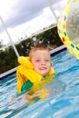 Little boy swimming with life vest on Royalty Free Stock Photo