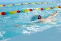 Little boy swimming in pool, kid in glass learning swim by crawls . Sport and hardening. Healthy mind. children`s wellness center