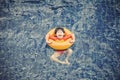 Little boy in the swimming pool with rubber ring Royalty Free Stock Photo
