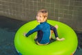 Little boy swimming with rubber ring at the leisure center Royalty Free Stock Photo