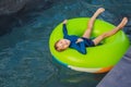 Little boy swimming with rubber ring at the leisure center Royalty Free Stock Photo