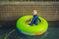 Little boy swimming with rubber ring at the leisure center Royalty Free Stock Photo