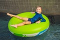 Little boy swimming with rubber ring at the leisure center Royalty Free Stock Photo
