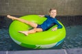 Little boy swimming with rubber ring at the leisure center Royalty Free Stock Photo