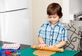 Boy swinging a rolling pin cookie dough Royalty Free Stock Photo