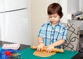 Boy swinging a rolling pin cookie dough Royalty Free Stock Photo