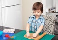 Boy swinging a rolling pin cookie dough Royalty Free Stock Photo
