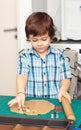 Boy swinging a rolling pin cookie dough Royalty Free Stock Photo