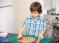 Boy swinging a rolling pin cookie dough Royalty Free Stock Photo