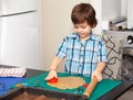 Boy swinging a rolling pin cookie dough Royalty Free Stock Photo