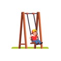 Little boy swinging on swing on public playground Royalty Free Stock Photo