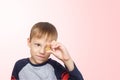 Little boy takes fish oil. Vitamins D, E. The child holding omega-3 capsule between his fingers. Healthy nutrition. Copy spase Royalty Free Stock Photo